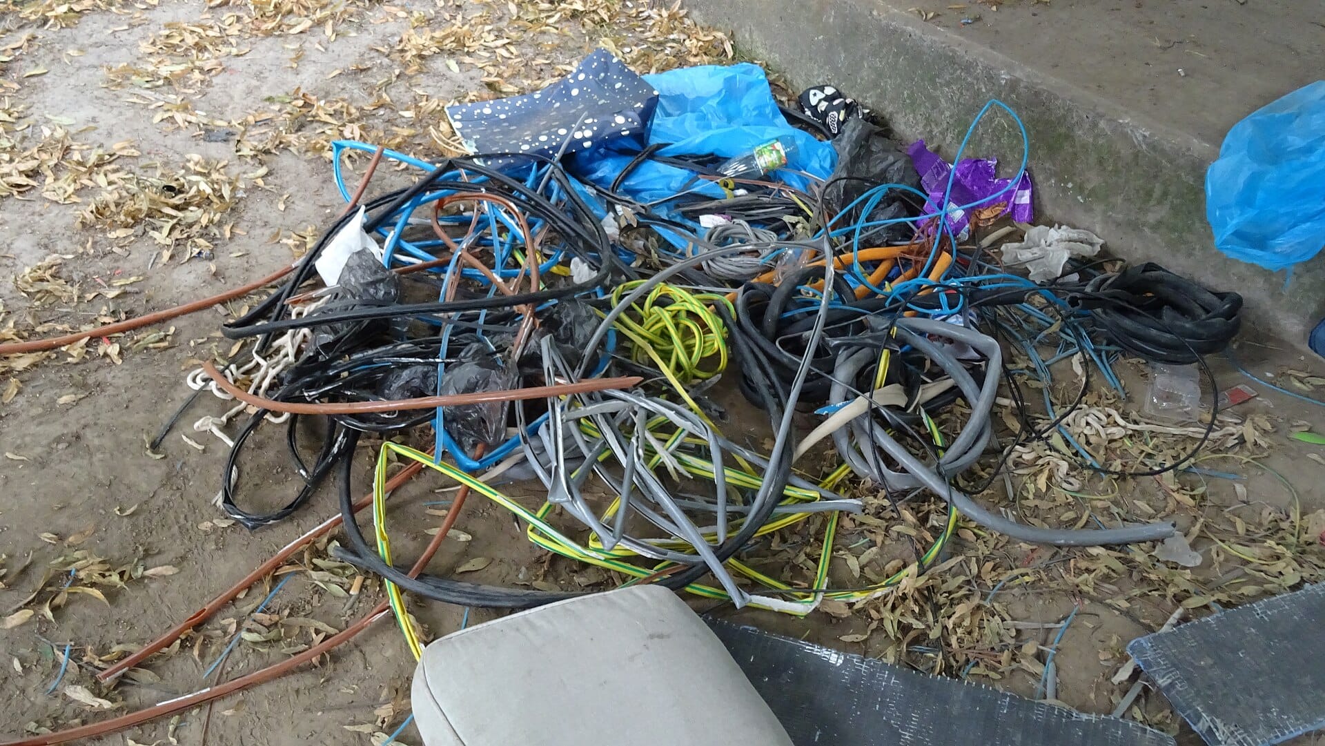 Stripped cable sheathing and cut ends dumped on the ground after the copper cores were stolen