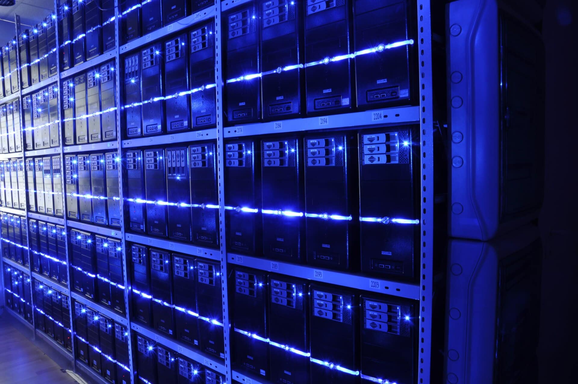 Rows of blue-lit servers in data centre racks, the backend infrastructure behind an API