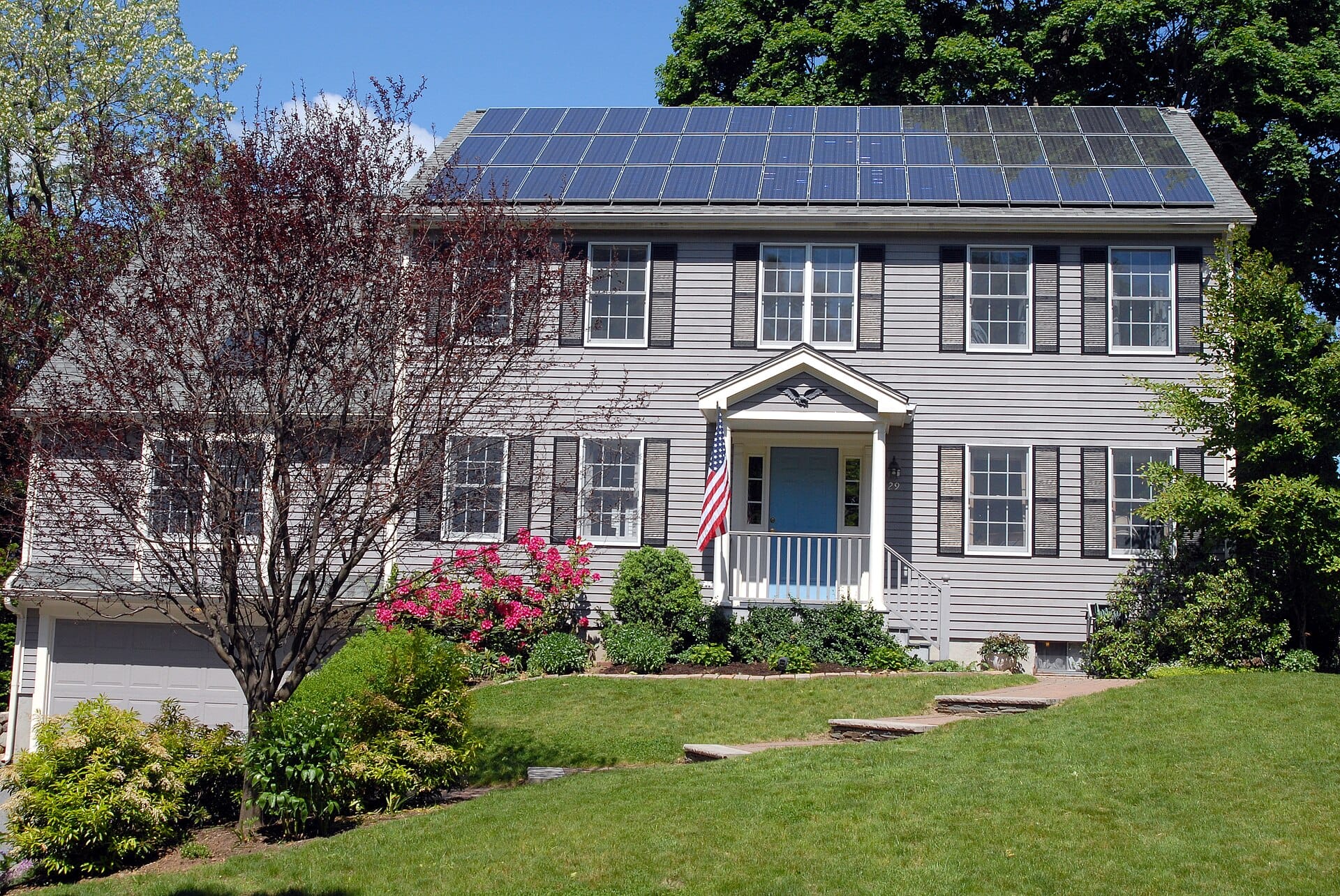 Two-storey detached house with a large array of solar panels covering the front roof slope