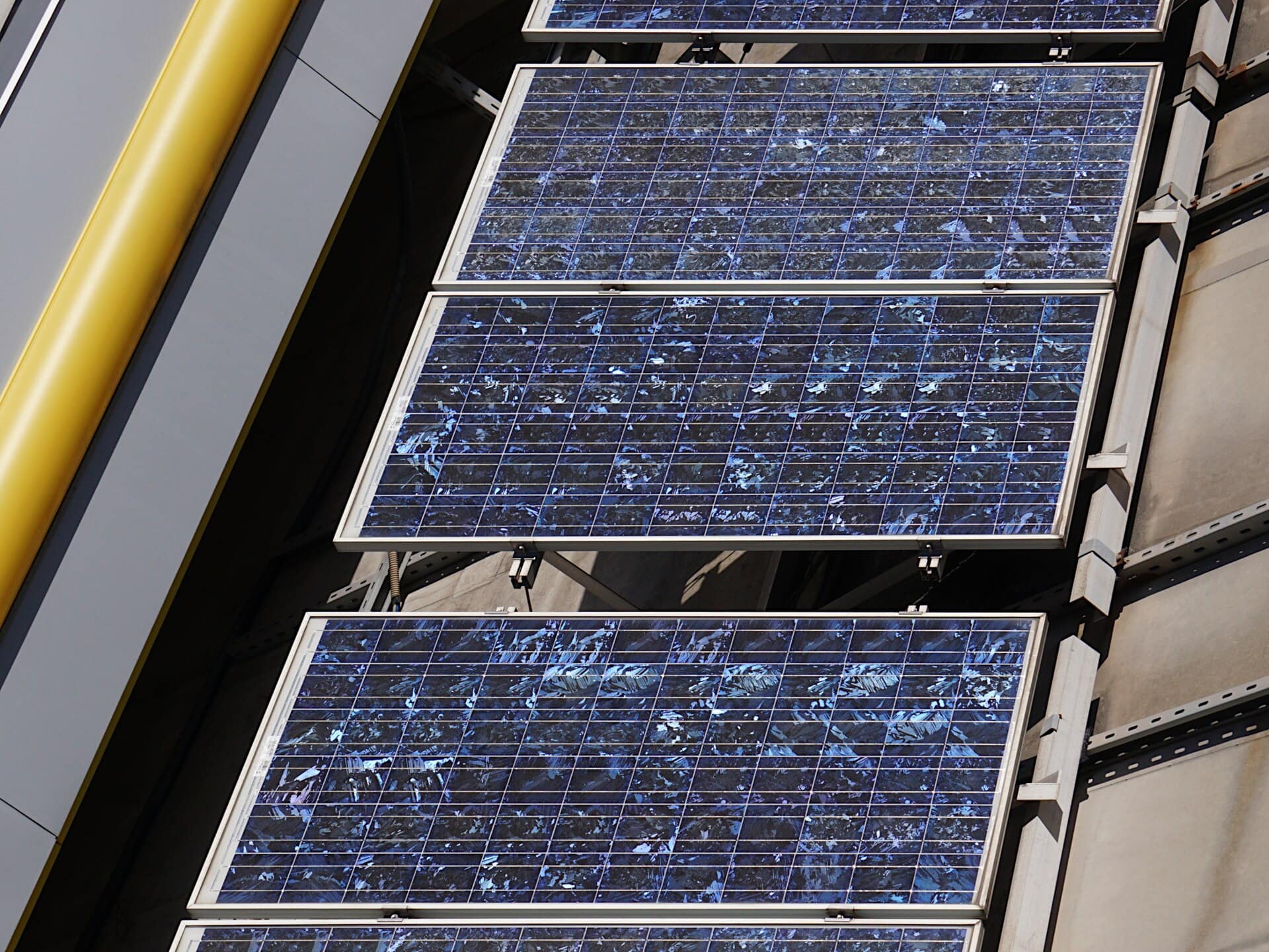 Close-up of polycrystalline solar panels showing the mottled, marbled texture of multi-crystal cells
