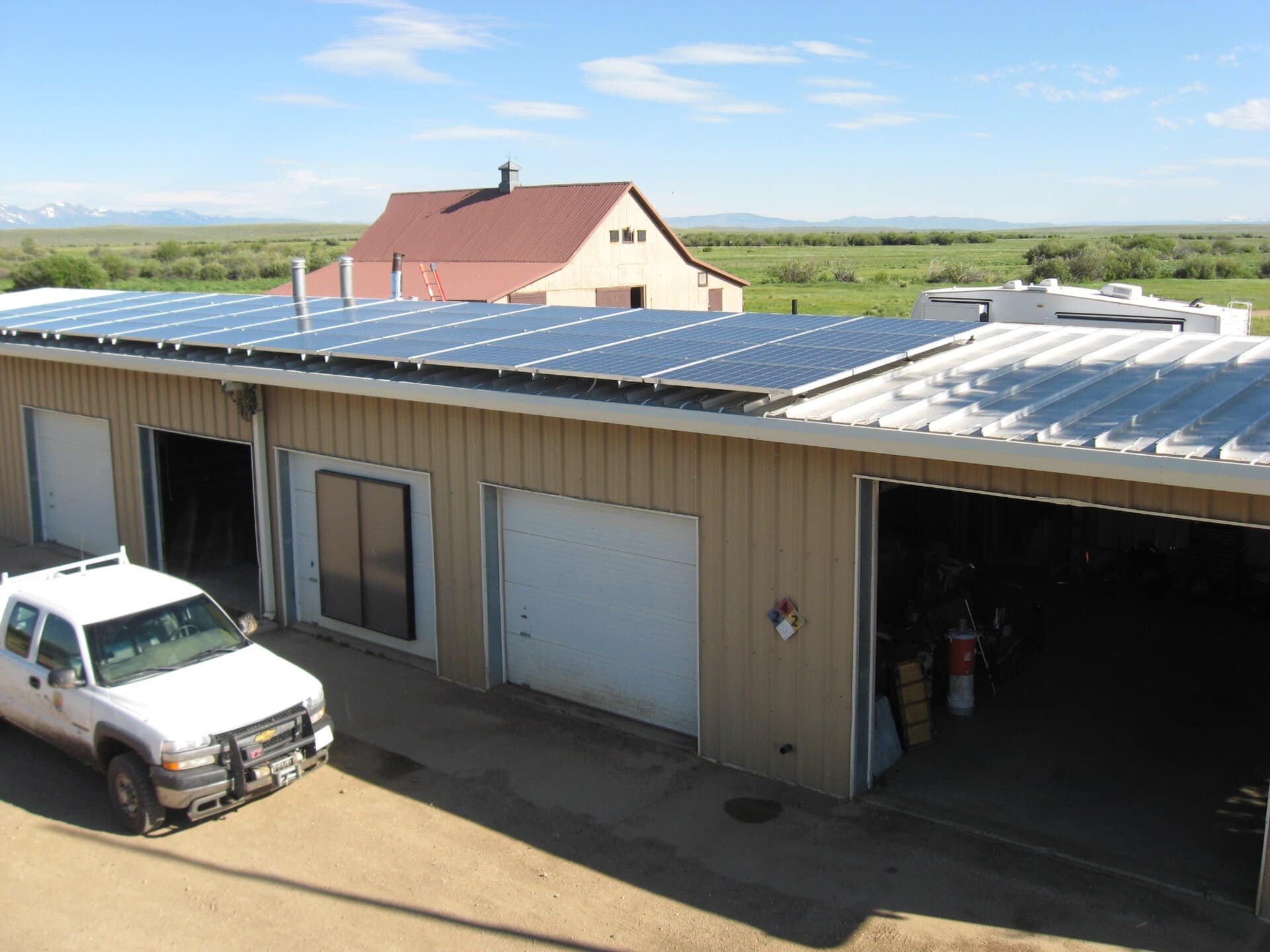 Small commercial workshop building with a solar array covering most of its low pitched roof