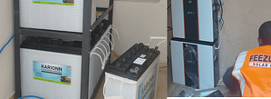 Gallery 267 Street-level solar installation scene with battery units and a technician