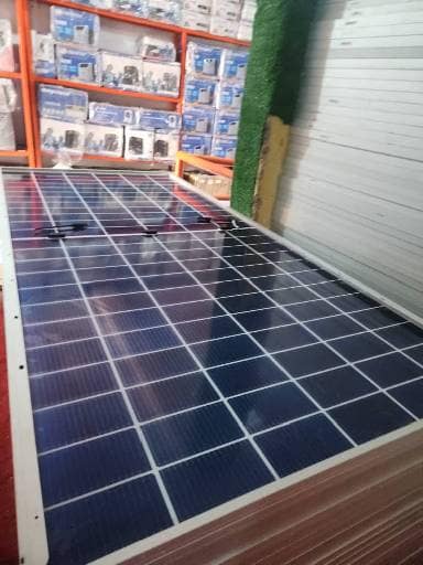 700W Solar Panel 4 Long row of solar panels laid out in a store room