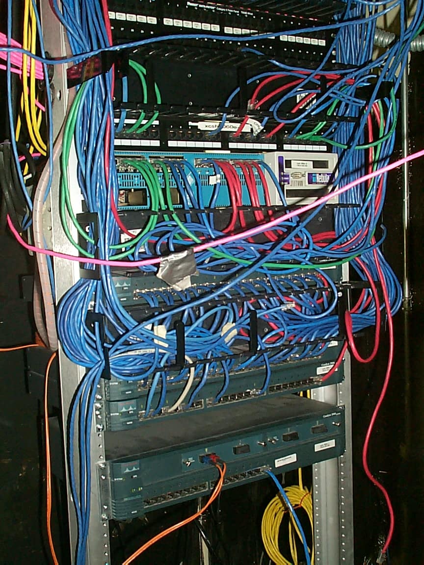 Network rack of switches and cabling, the kind of infrastructure network penetration testing targets