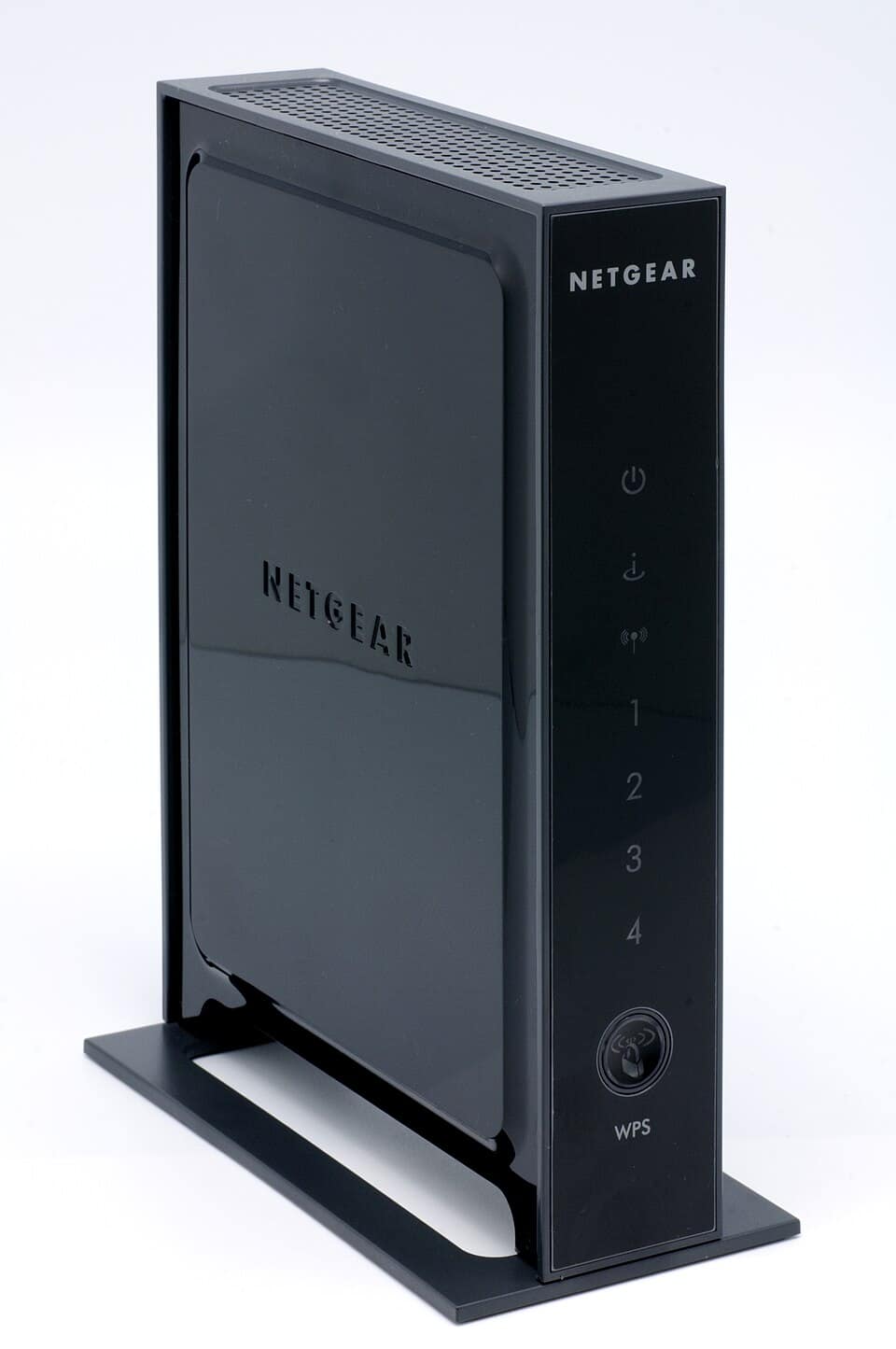 Netgear wireless router standing upright with status lights, the kind of device a vulnerability assessment scans